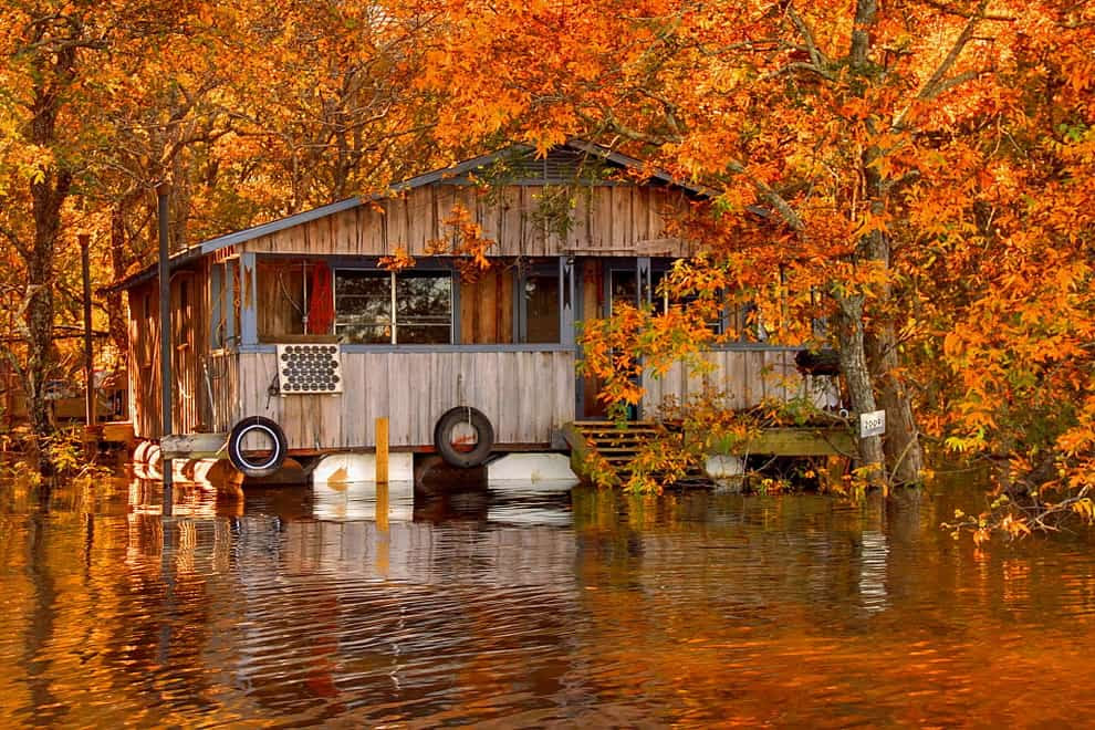 Fall foliage and floating camp on the Ouachita River in Louisiana