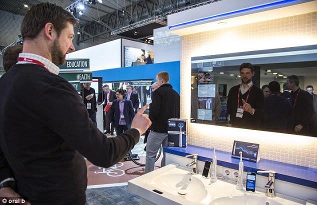 The connected mirror, pictured, is a concept designed by Oral B.The firm added a motion sensor to a sink and when a person waves their hand in front of it, the interactive mirror is enabled. By swiping their hand up or down, users can scroll through a menu in the same way they would on a smartphone