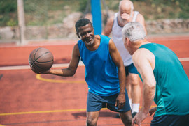 Veterans playing basketball together 