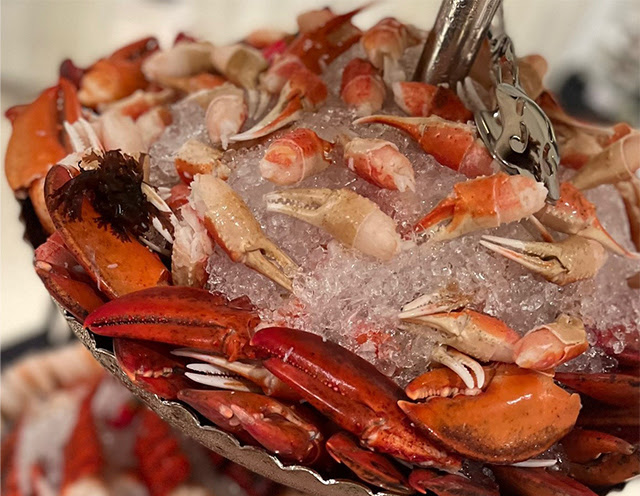 Close up of a crab claws in a platter filled with ice