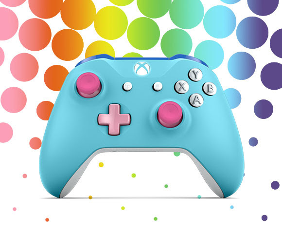 Light blue controller with pink buttons in front of a rainbow-colored backdrop.