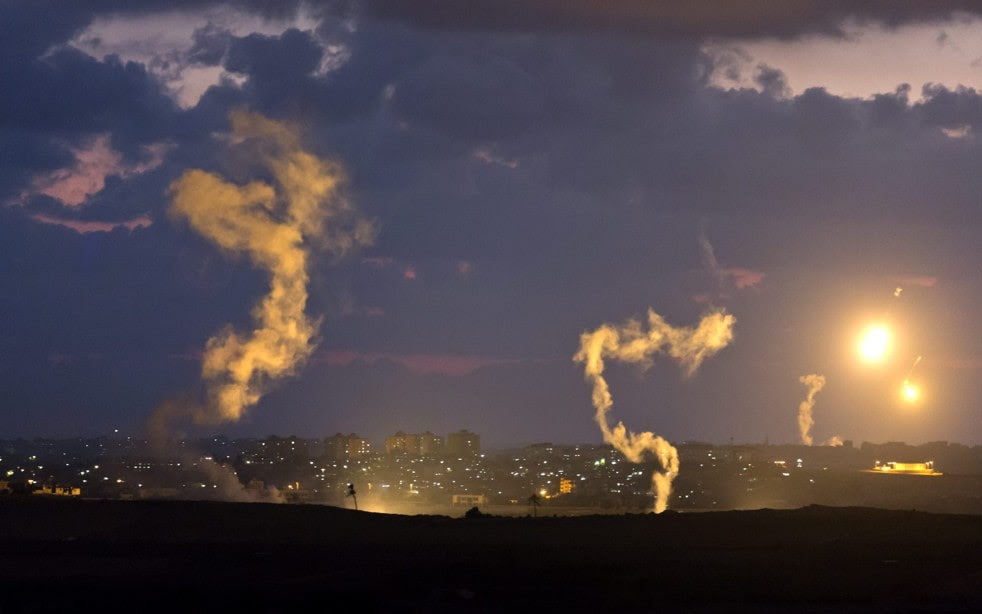 Two Israeli flares loose their light power as two others light up the sky over the northern part of the Gaza Strip. (Jim Hollander/EPA)