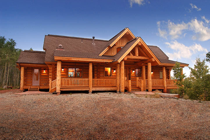 The spacious porch accommodates the trunks of tall pines giving it a treehouse feel. Exterior Photos Of Log Homes And Timber Homes