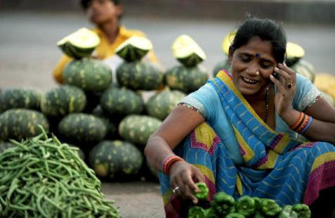 An Indian vegatable seller arranges vega