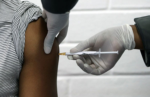 A medical worker injects a patient with a potential vaccine against the COVID-19 coronavirus.