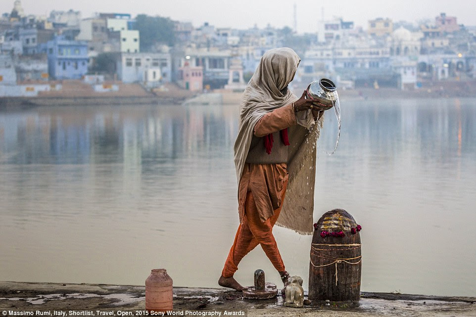 Aquarian: A man spills water collected from the lake in Pushkar, Rajasthan, India, in this submission to the Travel category