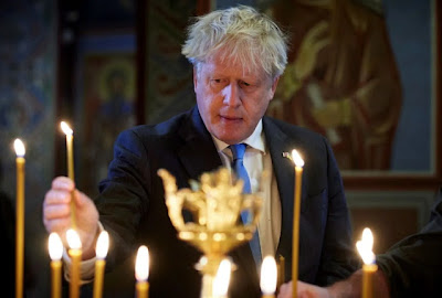 FILE PHOTO: British Prime Minister Boris Johnson lighting candles at the St. Mikhailovsky Cathedral in Kyiv (Kiev), Ukraine, 17 June 2022. EPA, UKRAINIAN PRESIDENTIAL PRESS SERVICE HANDOUT