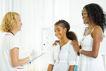 Image of a mother and daughter speaking with a clinician.