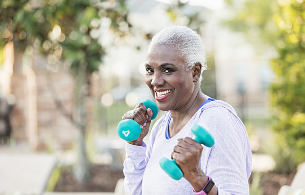 A senior woman exercising with hand weights.