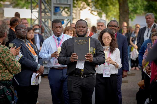 Participants carry the Bible into the opening ceremonies of the 11th Assembly of the World Council of Churches.