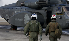 Rear Adm. J.R. Haley walks to an MH-53E Sea Dragon helicopter.