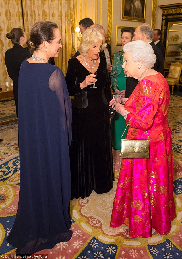 Camilla olhou melhor para ele com um vestido de veludo preto, no chão, enquanto passava o tempo conversando com a Rainha e seus convidados