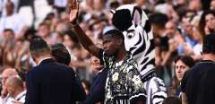 Juventus' French midfielder Paul Pogba, who is currently injured, waves from a tribune prior to the Italian Serie A football match between Juventus and AS Roma on August 27, 2022 at the JUventus stadium in Turin. (Photo by Marco BERTORELLO / AFP)