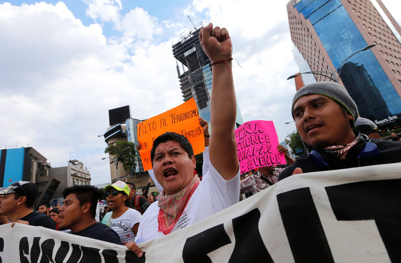 Protesters from the National Coordinator of Education Workers (CNTE) teachers’ union march against President Enrique Peña Nieto