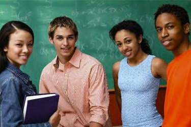 High school age students in front of chalk board