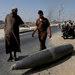 An unexploded bomb drew Palestinian onlookers on Friday on a main road in Deir el-Balah in the central Gaza Strip.