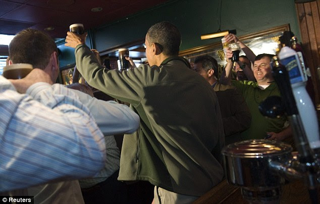 Cheers: Wearing a moss green jacket and a button reading 'VIP GUEST - Tell 'em Danny sent you,' the president hoisted a pint above the crowd