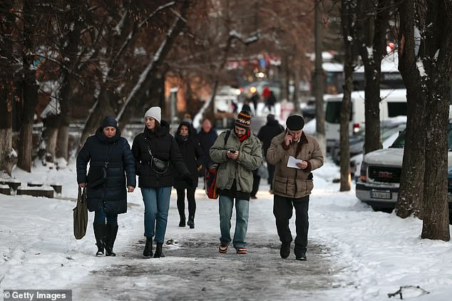 Winter is now beginning in Ukraine with temperatures regularly dropping below freezing leaving people shivering in their homes (pictured, snow in Kyiv on Wednesday)