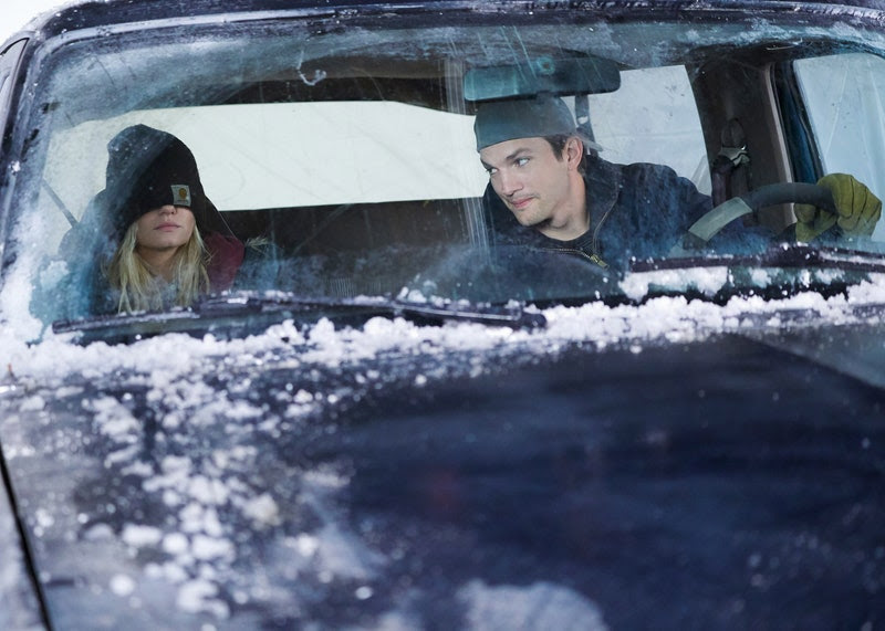 (image) Elisha Cuthbert and Ashton Kutcher sit in a car covered in snow.