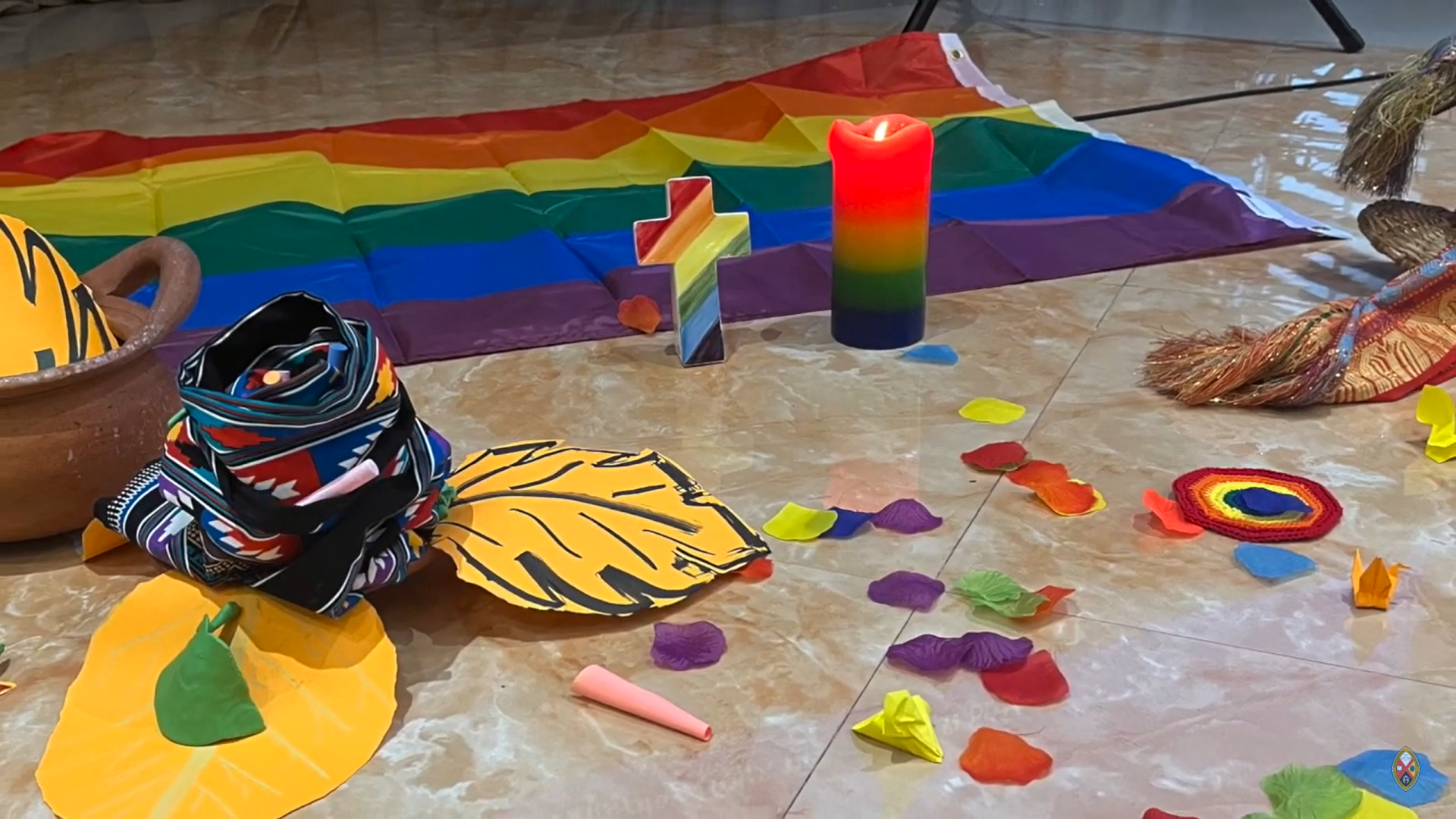 a consultation with Mission & Service partners in Asia provided a safe space for gender and sexual minorities to share their personal and collective struggles and gains: Rainbow cross, flag and flower petals are spread on the meeting room.