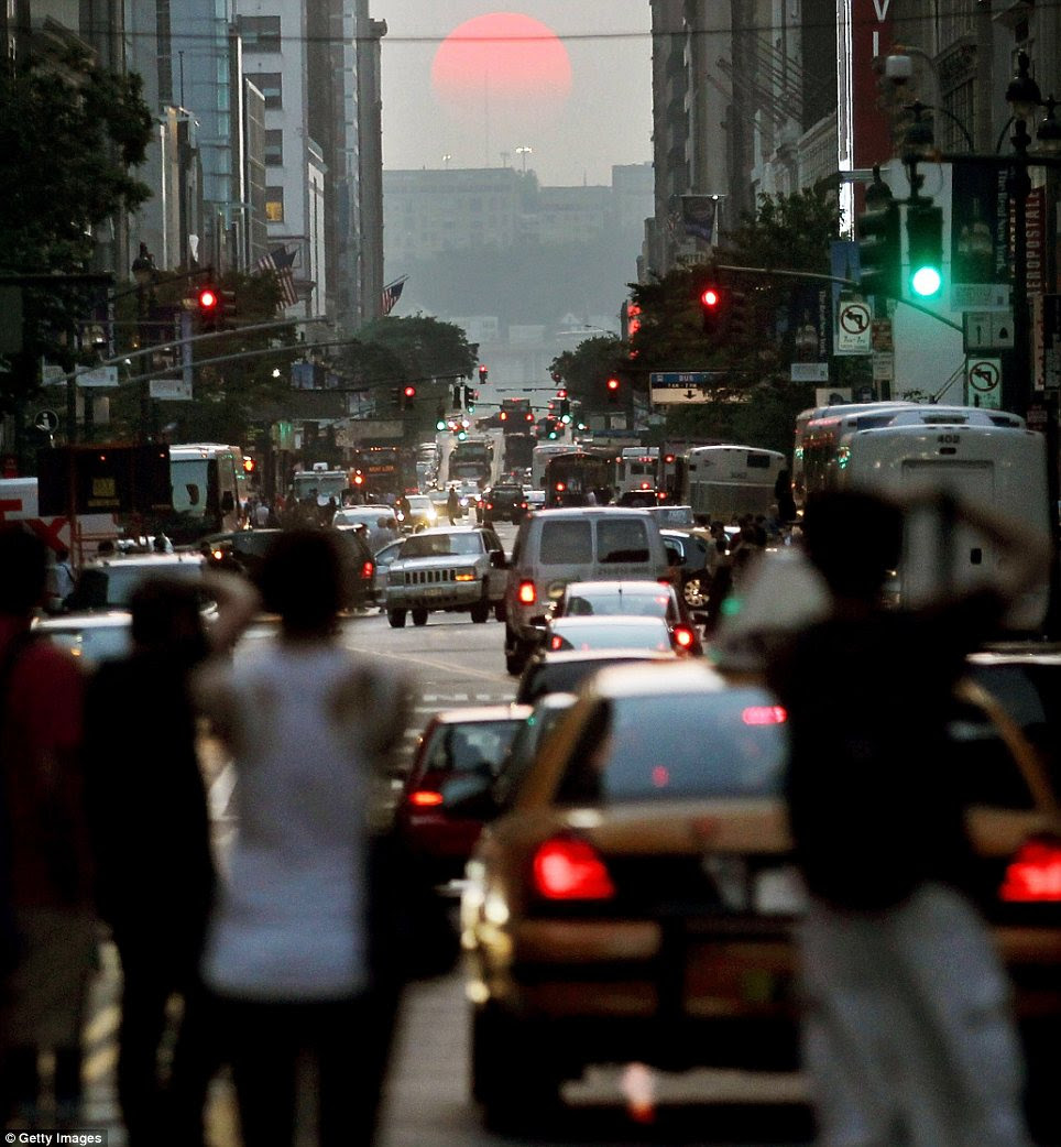 Red sky at night: New Yorkers snap the setting sun as it sets on West 34th Street during Manhattanhenge 