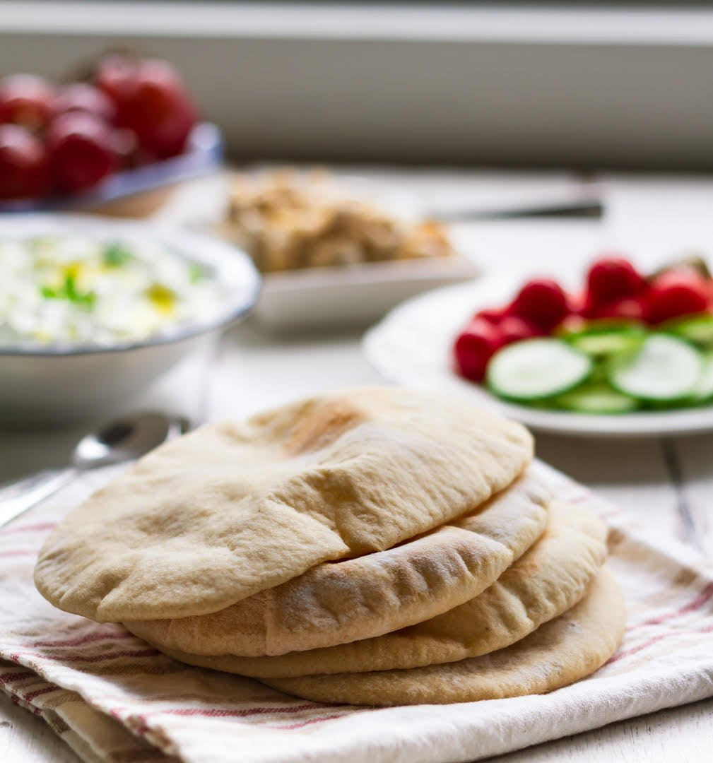 Lay pita bread into hot skillet and cook until bread begins to puff up and bottom has brown spots and blisters, about 3 minutes. Homemade Pita Bread Easy Pita Recipe Tasha S Artisan Foods