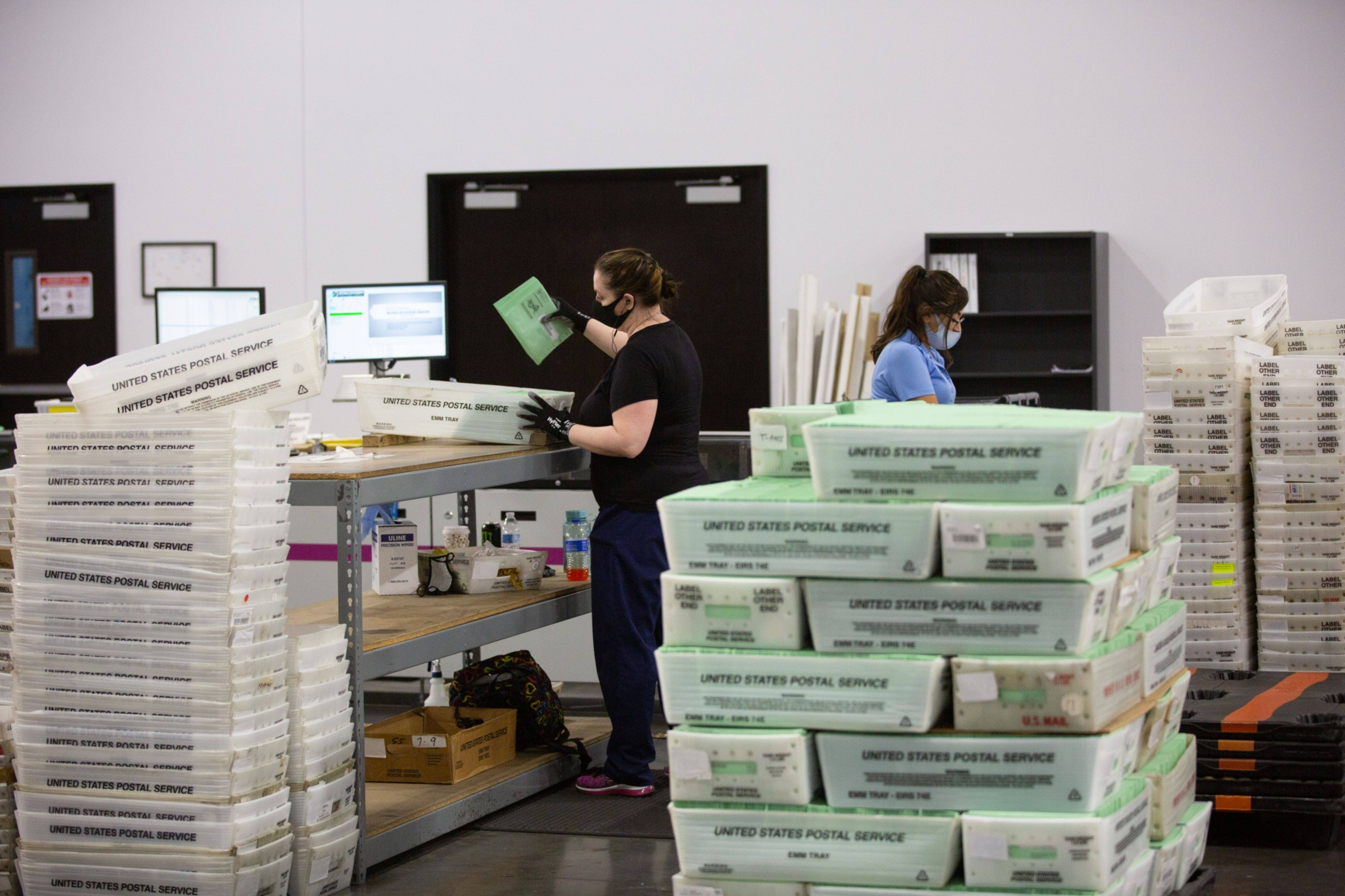 Workers sort ballots to mail out in Phoenix. (Caitlin O'Hara/Bloomberg News)