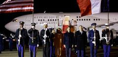 French President Emmanuel Macron (C) and his wife Brigitte Macron (C-L) arrive at Joint Base Andrews in Maryland on November 29, 2022. - Macron is in Washington to discuss a slew of issues with US counterpart Joe Biden, ranging from aligning policy on Russia's invasion of Ukraine to easing trade spats. (Photo by Ludovic MARIN / AFP)