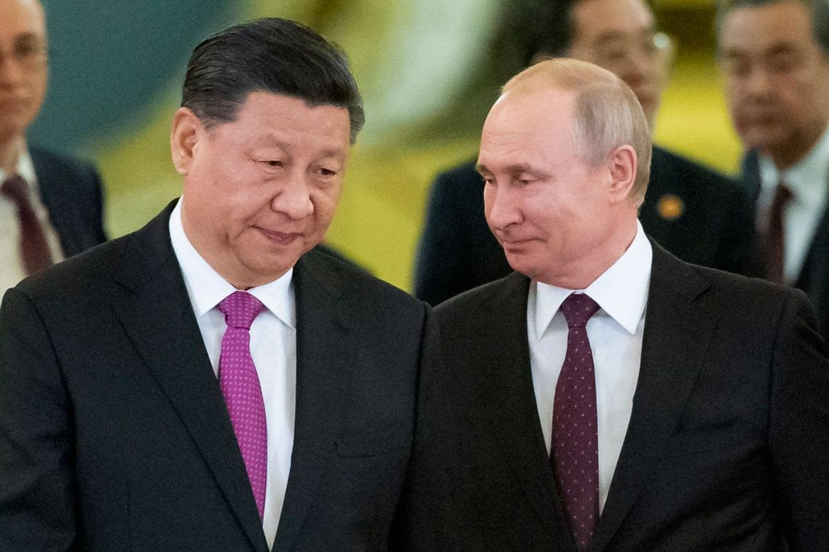 Photo of Xi and Putin seemingly conspiring.