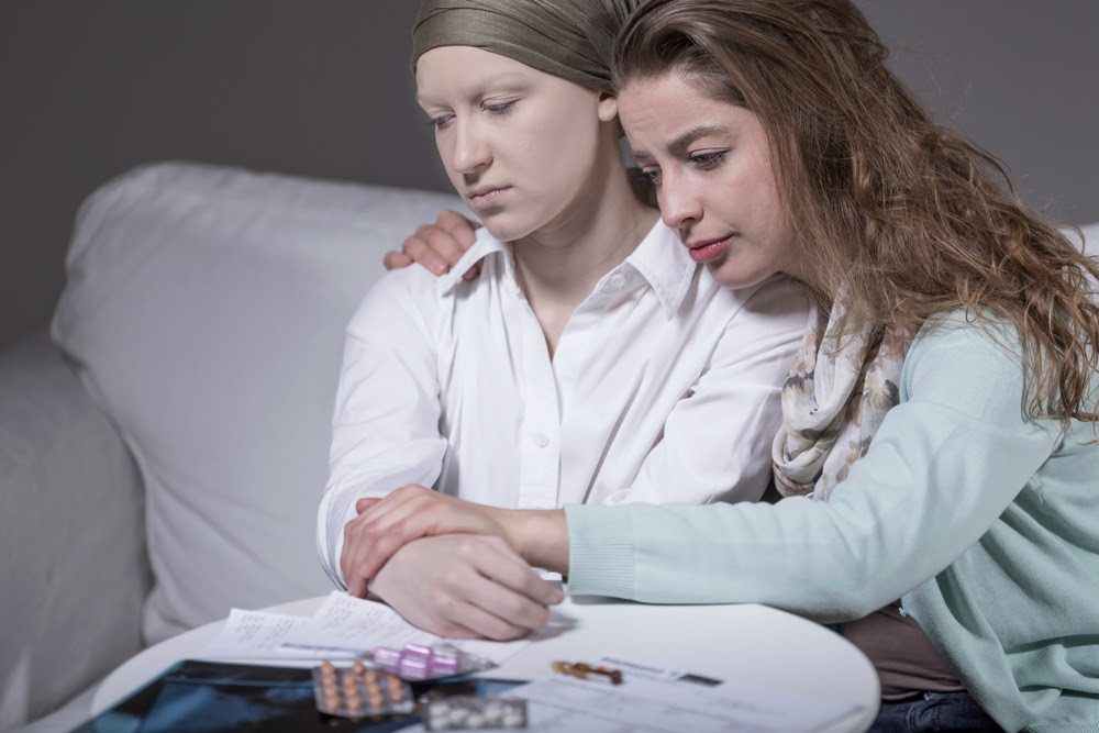Pretty young woman hugging her sick friend
