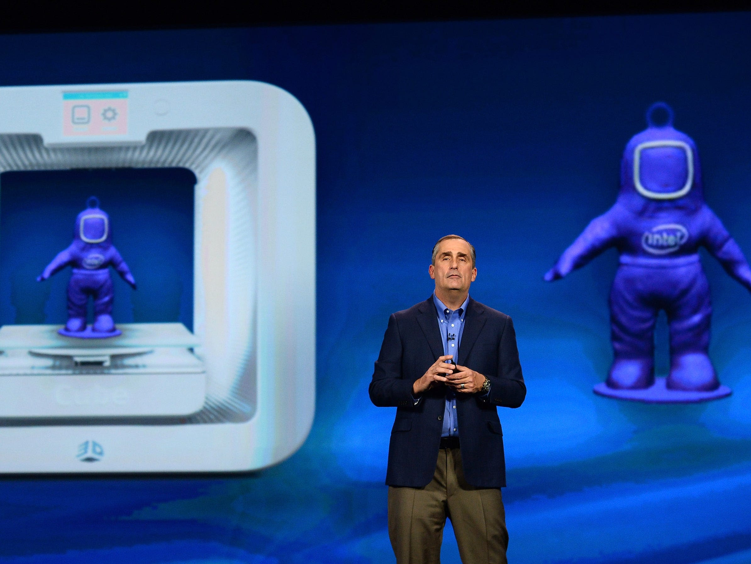 Intel  CEO Brian Krzanich delivers a keynote address in front of an image of a 3D Systems Cube 3-D printer at the 2014 International CES at The Venetian Las Vegas on Jan. 6, 2014, in Las Vegas. .