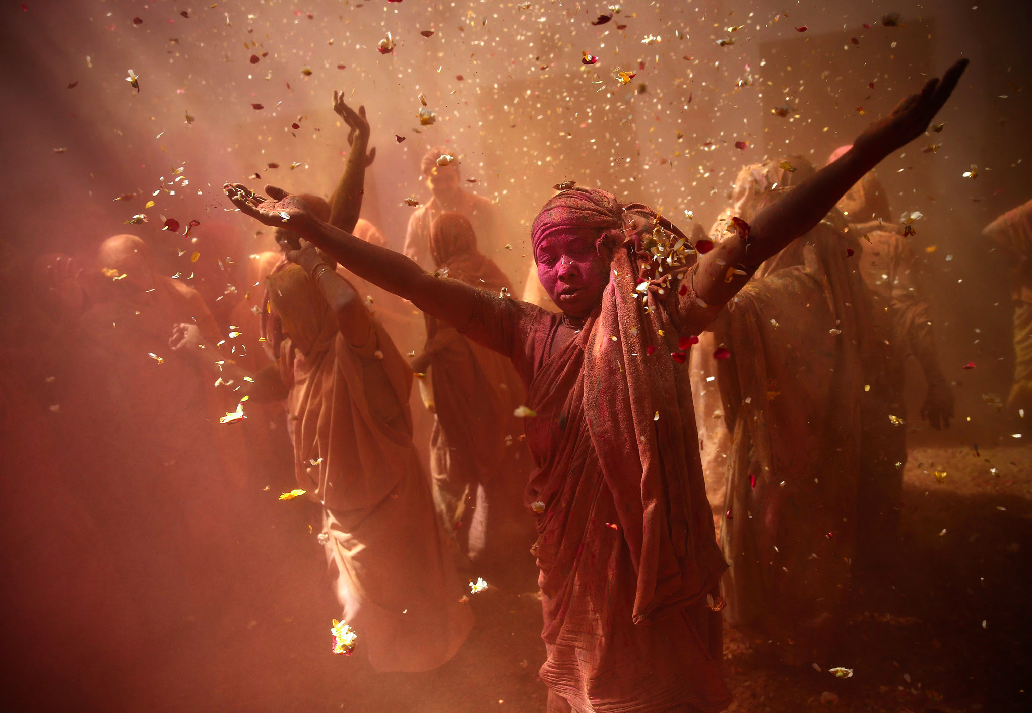 Widows daubed in colours dance as they take part in the Holi, or Festival of Colours, at a widows' ashram at Vrindavan in the northern Indian state of Uttar. Traditionally in Hindu culture, widows are expected to renounce earthly pleasure so they do not celebrate Holi. But women at the shelter for widows, who have been abandoned by their families, celebrate the festival by throwing flowers and coloured powder. 