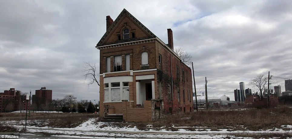 Vacant: A house planks-up empties into Brush Park neighborhood once thriving with the downtown Detroit skyline behind her