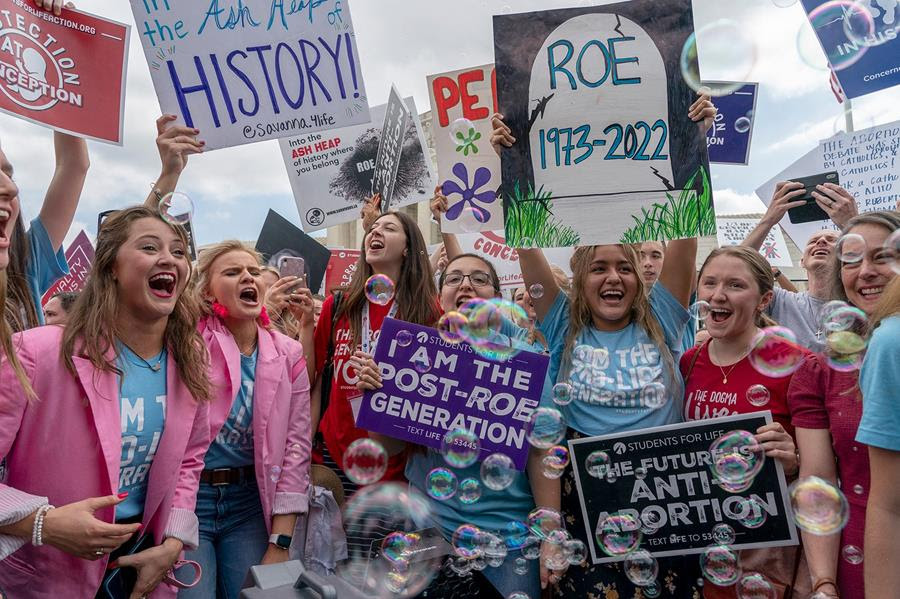 Anti-abortion protesters celebrate following Supreme Court's decision to overturn Roe v. Wade.