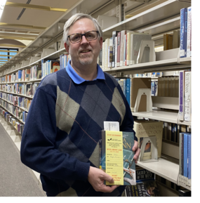 Charles Whittaker Holding a Book