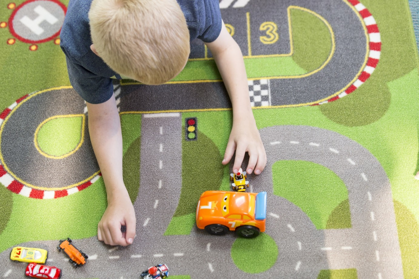 child playing with cars