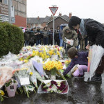 Kyonka and Marika O'Neil leave flowers in tribute to Asad Shah outside his shop in Shawlands, Glasgow, as a second vigil has been held for the well-respected Muslim shopkeeper who was killed in what police are treating as a "religiously prejudiced" attack. PRESS ASSOCIATION Photo. Picture date: Saturday March 26, 2016. Mr Shah was found seriously injured outside his shop in Minard Road in the Shawlands area of Glasgow on Thursday night and pronounced dead on arrival at hospital. See PA story POLICE Shopkeeper. Photo credit should read: John Linton/PA Wire