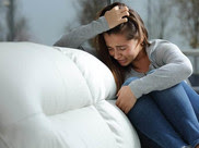 woman crying on couch