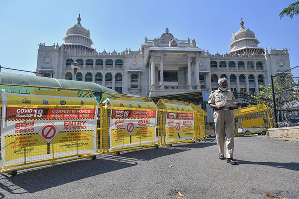 A police officer walks past barricades in Bangalore.