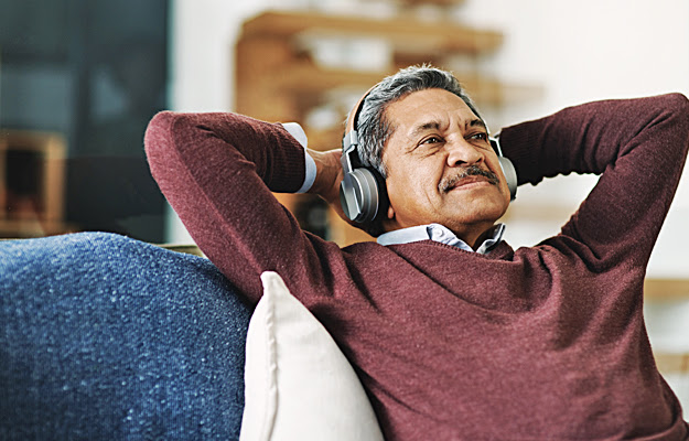 A senior man wearing headphones.