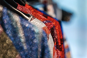 Sparkling details of colourful clothes displayed on hangers