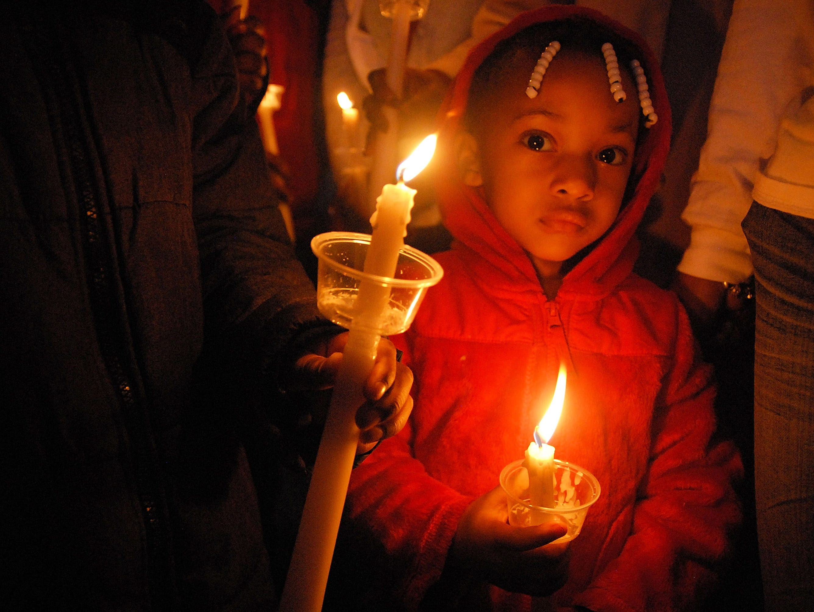 People lit candles at the Bobbi Kristina Brown public vigil at Riverdale Town Center on Feb. 9  in Riverdale, Ga.