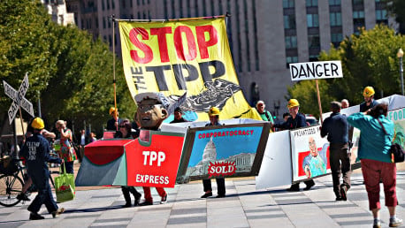 Demonstrators protesting against the Trans-Pacific Partnership (TPP) are seen on Pennsylvania Avenue, near the White House, on September 24, 2013 in Washington, DC. The TPP is a proposed free trade agreement being negotiated by  Australia, Brunei, Canada, Chile, Japan, Malaysia, Mexico, New Zealand, Peru, Singapore, the United States and Vietnam. AFP PHOTO/Mandel NGAN