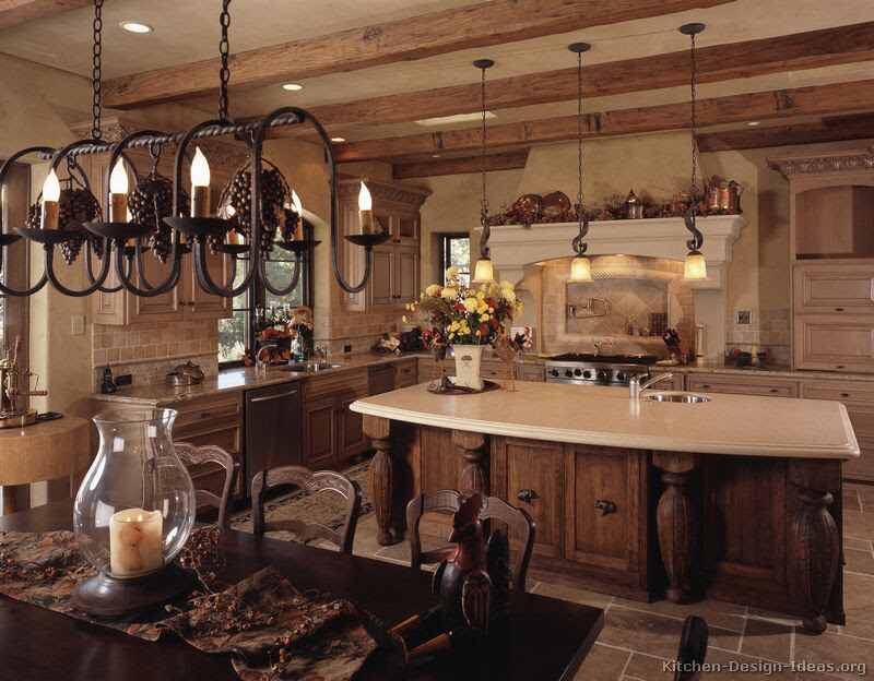 All white kitchen with white moldings and cabinetry, wood top island, wide plank wood flooring, brass hardware. French Country Kitchens Photo Gallery And Design Ideas