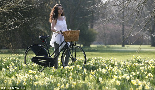 Riding out: Rachael Foister enjoys the hot weather and spring daffodils at West Dean College, West Sussex