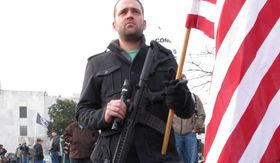 FILE -This Feb. 8, 2013, file photo, Arin Forrest of Portland, Ore.,  holds an AR-15 rifle at a pro-gun rally outside the state Capitol in Salem, Ore.  With a stronger Democratic majority in the Oregon Legislature, gun safety advocates are hoping the third time will be the charm on a bill to expand the use of background checks for gun sales. (AP Photo/Jonathan J. Cooper, file)