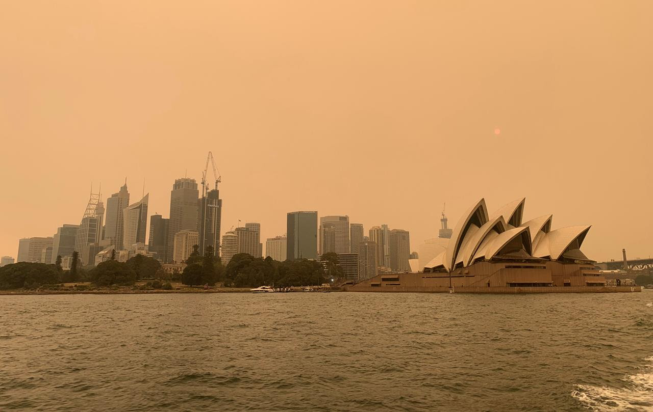 The haze from bushfires obscures the sun setting above the Sydney Opera House in Sydney, Australia, December 6, 2019.