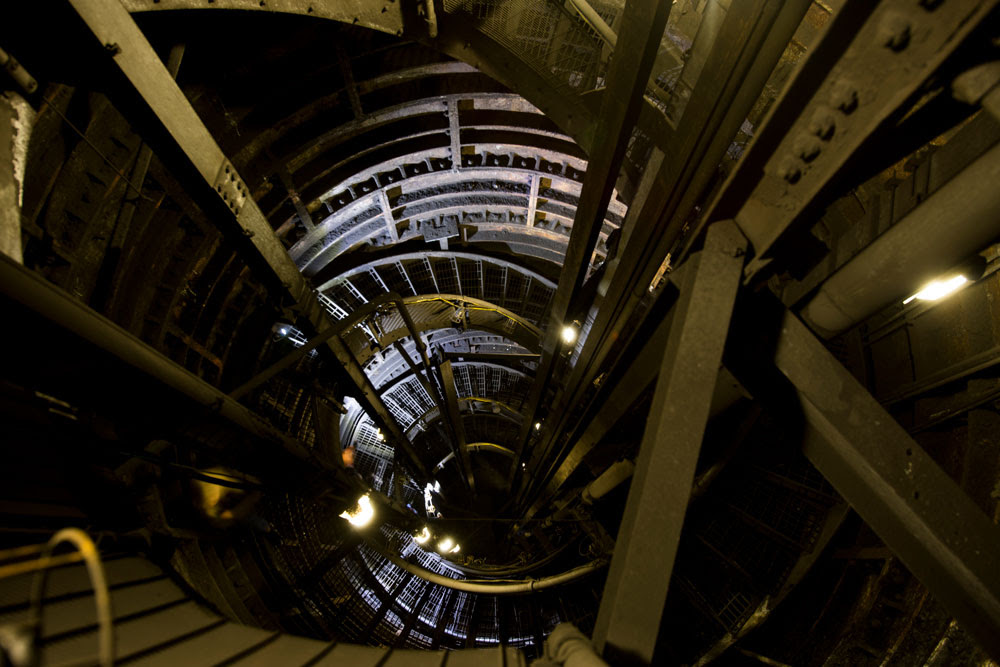 Looking up into a complex series of underground staircases