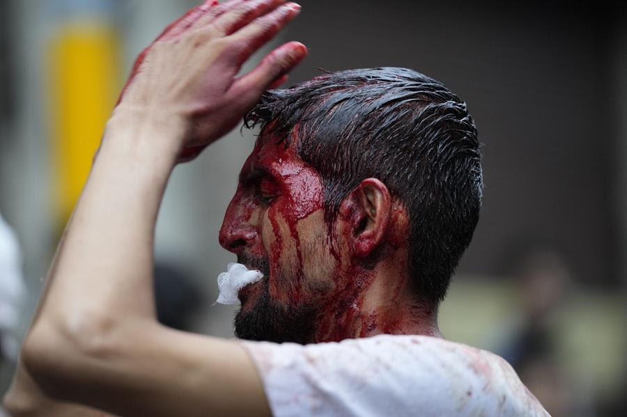 An Indian Shiite Muslim flagellates himself during an Ashoura procession.