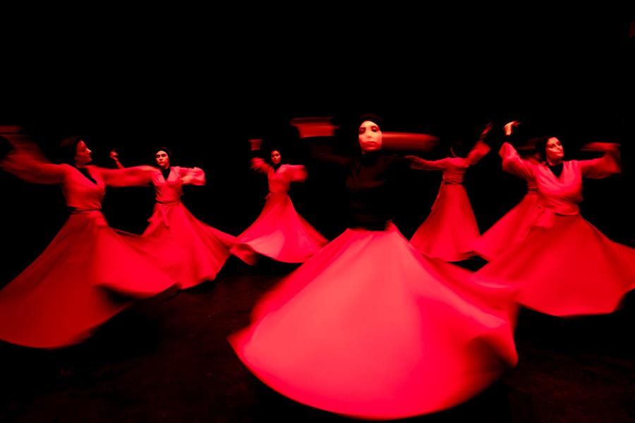 Khishtan art group performs the Sama dance, or a Sufi dance, at a theater hall in downtown Tehran, Iran, Friday, Oct. 15, 2021. Sama is a popular form of worship in Sufism. (AP Photo/Ebrahim Noroozi)